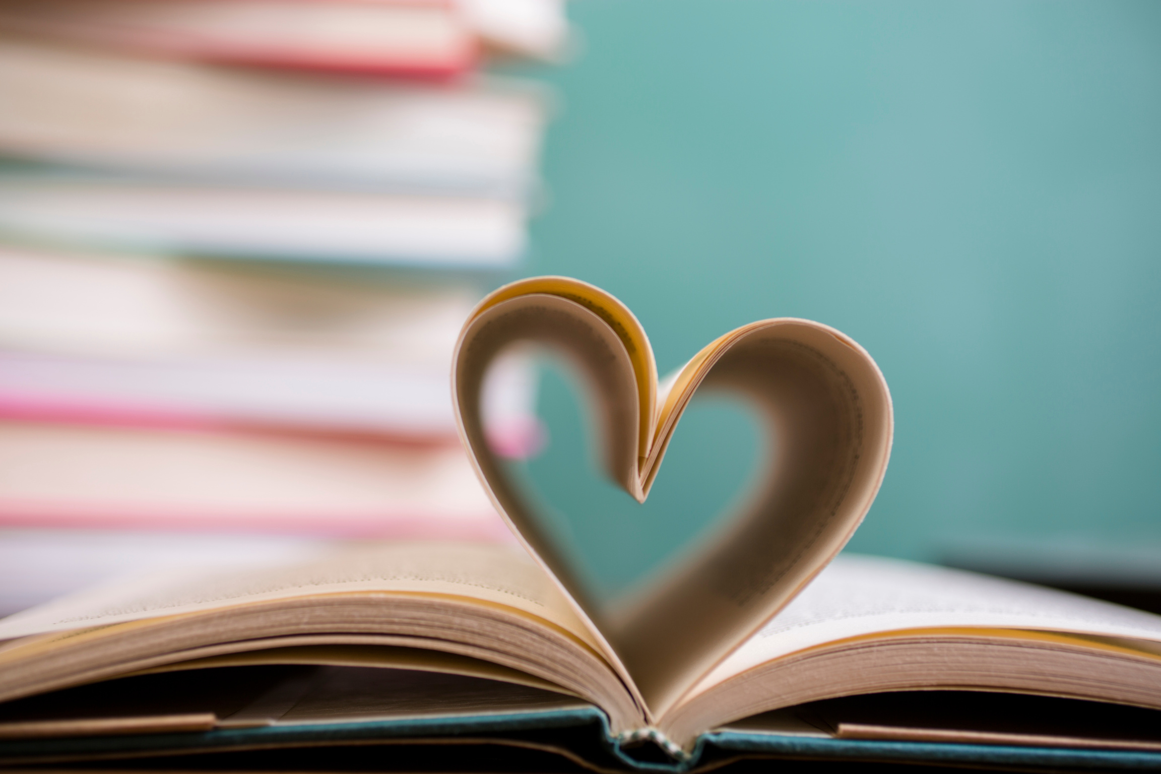 Heart shape in open school book pages.